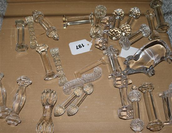 Fourteen pairs of cut glass knife rests and a glass pig